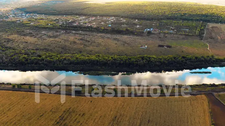 Flight in the beautiful countryside among a river of woods and fields near the city