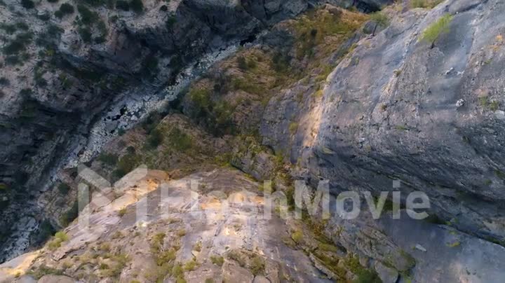 Top view of the mountain river. Stone gorge. Dry riverbed. Green plants on the rocks. Aerial drone video 4k footage