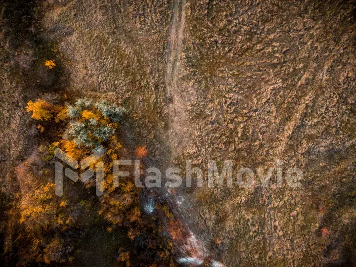 Cinematic 4k aerial view. Flying over green grassy rocky chalk hills, mountains and a river