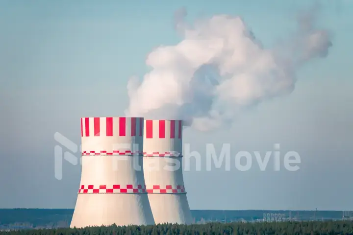 Nuclear power plant after sunset. Dusk landscape with big chimneys.