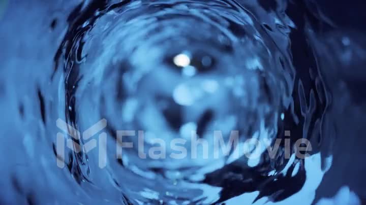 Water moves in a glass in slow motion. Abstract blue water background. Seamless loop 3d render