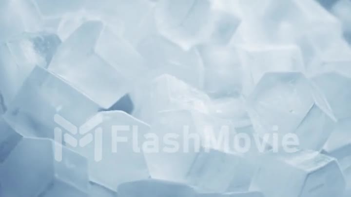 Macro shot of ice cubes from clear water that melt in slow motion on a white background. Concept: pure mountain spring water, ice, cocktails, fresh and frozen foods.