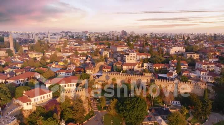 View over the red roofs and medieval wall of the old city. Sunset. Panorama. Aerial drone video footage.