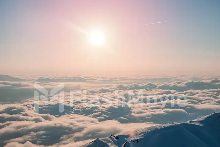 Alpine landscape of snow covered mountains and blue sky