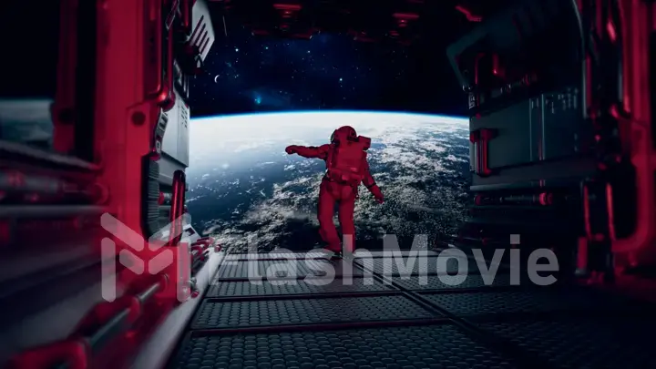 Space concept. Astronaut escape on a spaceship. Opening of the gate with a view of the planet Earth. Red spacesuit