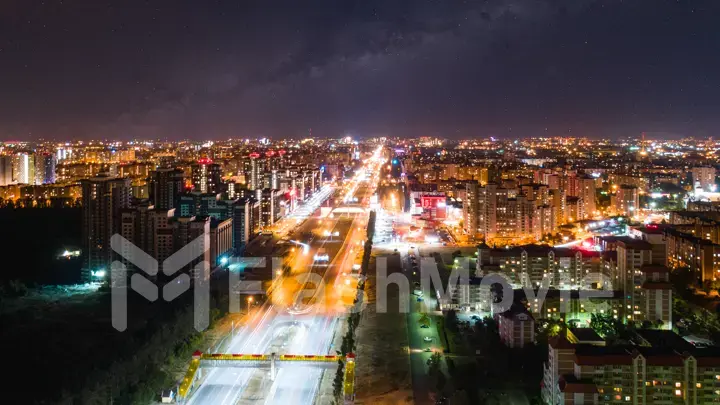 Night city under the starry sky. Bright city lights. Milky Way