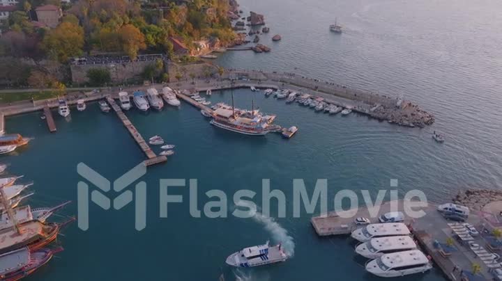 Aerial video footage from a drone. Top view from drone of harbor with yacht, motorboat and sailboat. Beautiful old port
