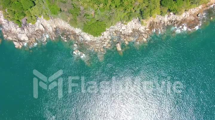 Top view moving up away ocean blue waves crash coastline cliff. Aerial 4k footage