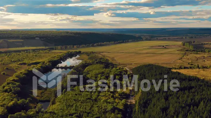 Flight in the beautiful countryside among a river of woods and fields near the city