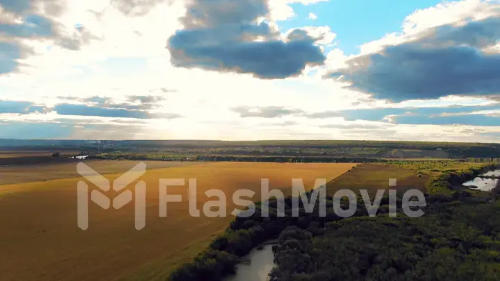 Flight in the beautiful countryside among a river of woods and fields near the city