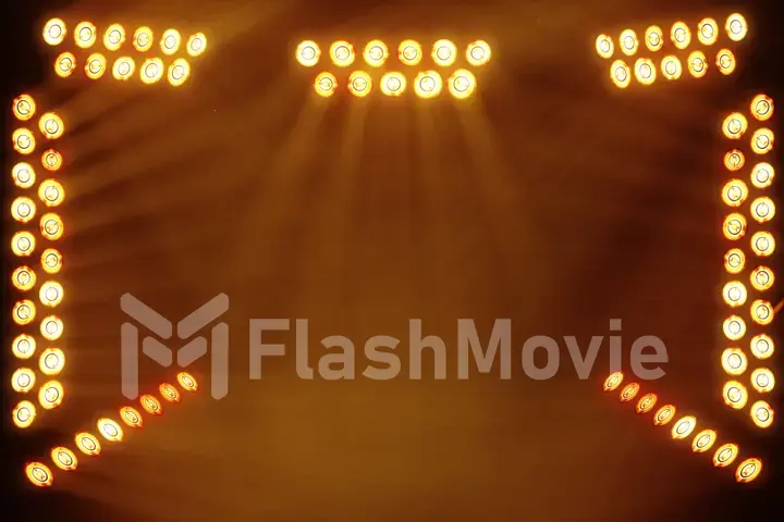 Bright stage lights flashing in orange color place for your text copy space