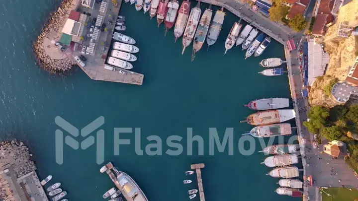 Aerial view of amazing boats. Marina bay. Top view from drone of harbor with yacht, motorboat and sailboat. Seascape