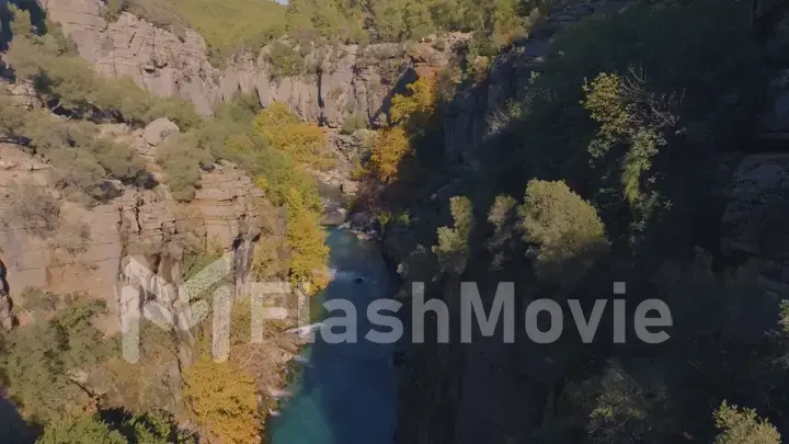 Top view of shallow river bed between green rocks. Mountain landscape. Wildlife. Tourism. Ecology