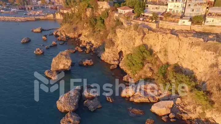 Old town, pier and ships in the background. Seascape. Rocks from the water. Picturesque bay. Top view