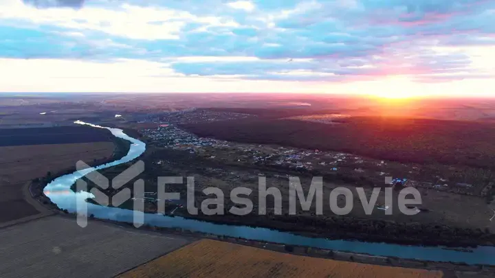 Flight in the beautiful countryside among a river of woods and fields near the city