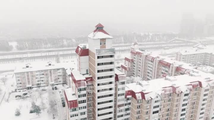 Aerial 4k View Flight on a day in the snow over a small military town, nice design houses