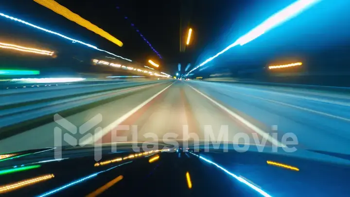 Driving a car in the city at night. The camera on the hood of the car. Hyperlapse in the evening in the center of the city on the highway. Abstract soft glowing lines.