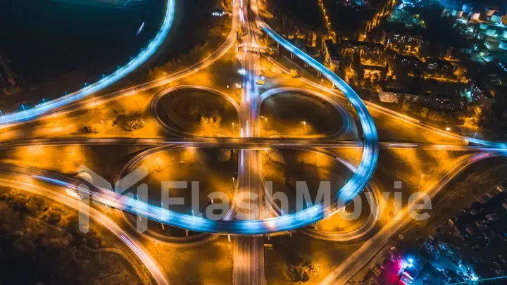 Aerial 4k view.Hyperlapse timelapse of Urban night traffic on a roundabout in the form of circles and eight