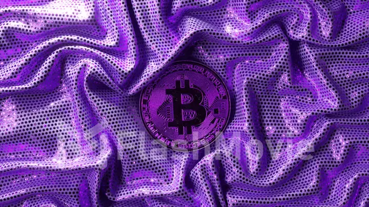 Cryptocurrency concept. The crumpled purple shiny fabric is straightened out and the bitcoin is opened.