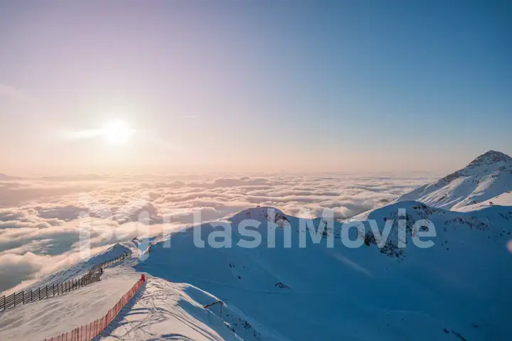 Alpine landscape of snow covered mountains and blue sky