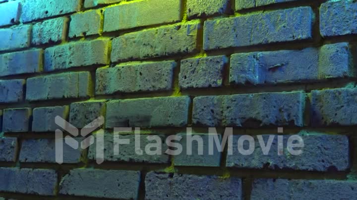 Empty brick wall with neon light, copy space. Light effect on a brick wall background. Modern light spectrum. Empty background.
