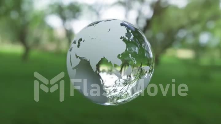 Eco concept. Glass globe ball shaped planet Earth rotates. Green nature blur background. 3d animation of seamless loop