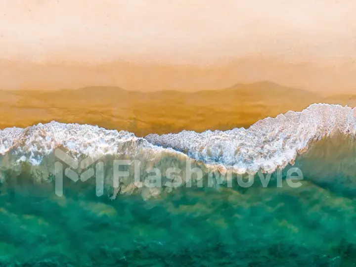 Top view on sandy beach and emerald ocean water. Aerial photography