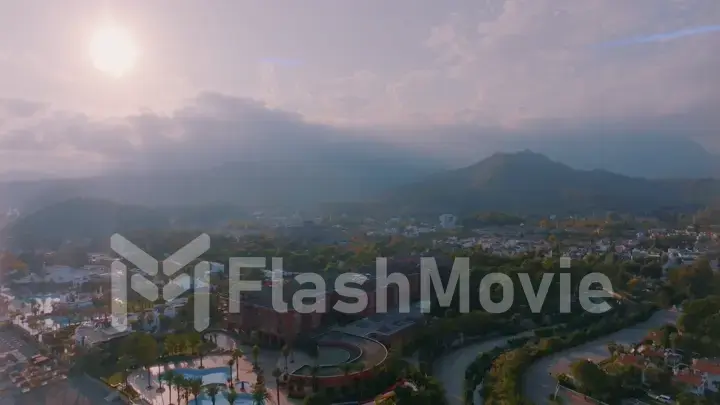 Beautiful landscape. Aerial view of the resort town. Sunset sky. Mountains in the background.