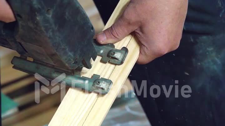 Close-up of electric jigsaw in action, Cutting board