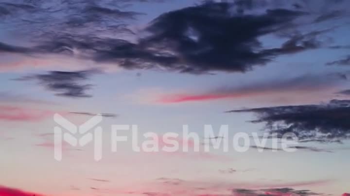 Dramatic sunset clouds after sunset with birds. Timelaps.