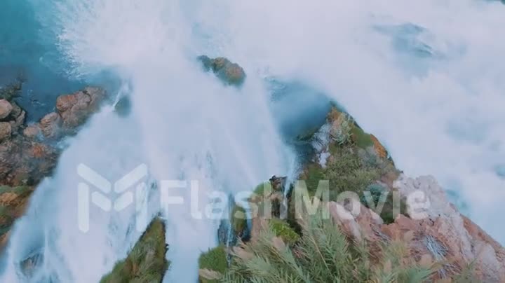Wonderful natural landscape. Slow motion shot of a stormy waterfall on a rock. Running water. Aerial drone footage