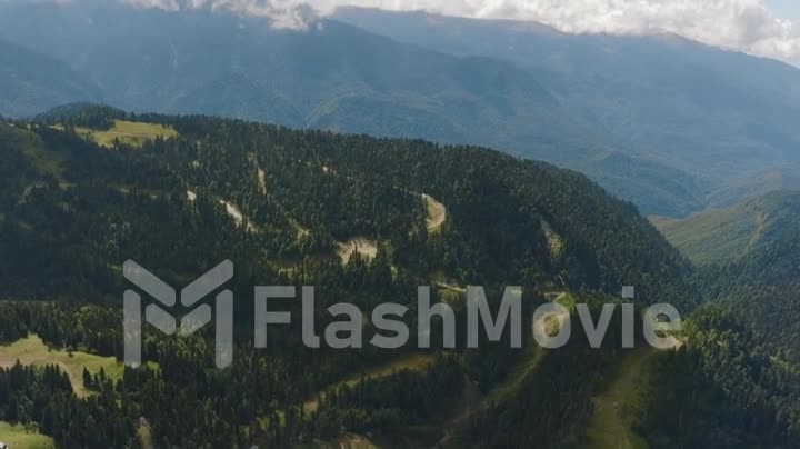 Beautiful mountain landscape. Drone video footage of green hills. Mountain peaks and green forests. White clouds