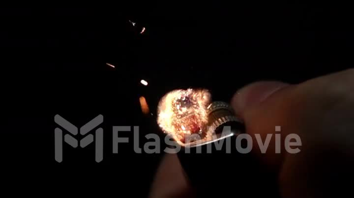 Using a lighters hand on a black background, slow motion
