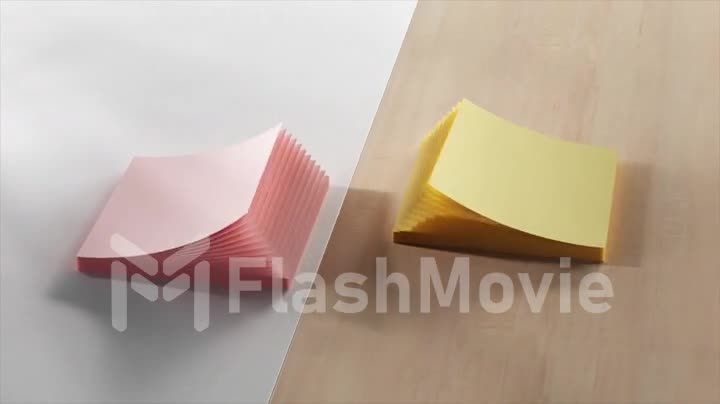 Top view of stacks of office stickers. Stationery. Adhesive colored paper. Open and close like a fan. Pink yellow color