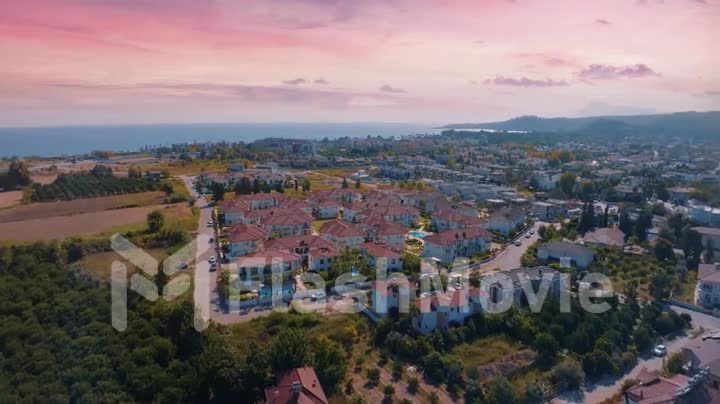 Aerial drone video footage. Panoramic view of the resort town against the backdrop of mountains. Top view of the city