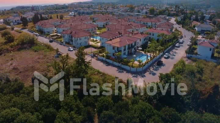 Aerial drone video footage. Panoramic view of the resort town against the backdrop of mountains. Top view of the city