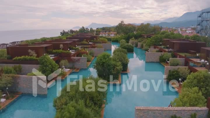 Drone footage of the hotel courtyard. Vacation at the resort. Green shrubs. Mountains in the background