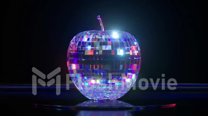 The blue disco apple spins on the platform reflecting the light. Dark and bright lighting. Mirror surface. Disco ball.