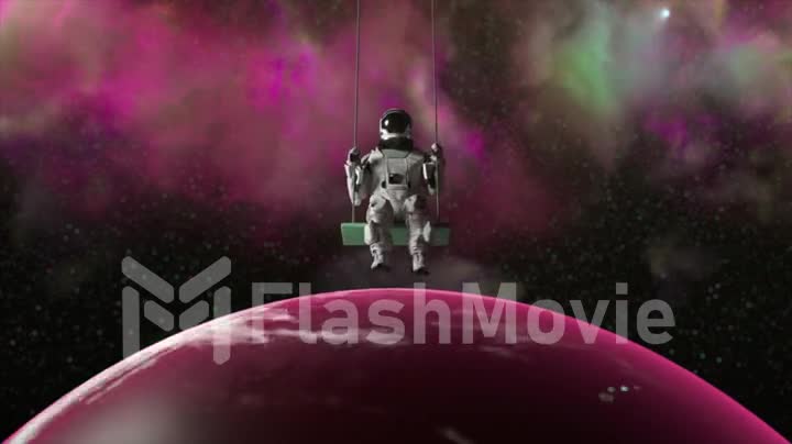 Space concept. Astronaut Swinging. Purple neon clouds in the background. Cosmonaut isolated silhouette.