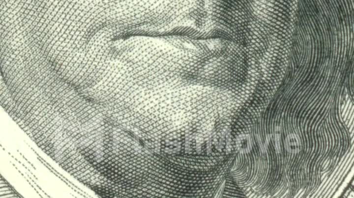 Animation of close-up of Ben Franklin winking on US one hundred dollar bill
