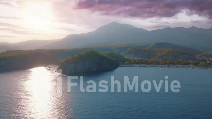 Seascapes shore at sunset. Panorama view of the blue bay against the backdrop of a mountain landscape. Drone footage