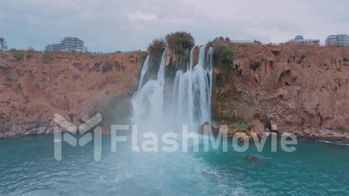 Beautiful stormy waterfall. Turquoise lagoon in a tourist place. Pure water. Drone video 4k footage.