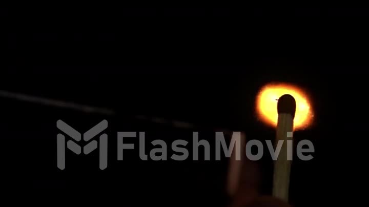 Burning match, bright firelight in slow motion