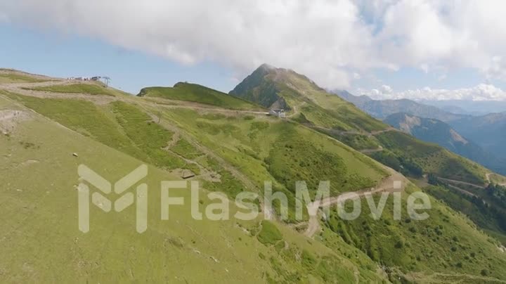 Top view of mountains, hills, roads and green trees. Wildlife. Beautiful landscape. Clouds. Drone video 4k footage