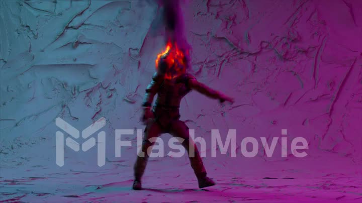 An astronaut with a burning head dances a modern dancing in front of purple illuminated lights. Abstract background.