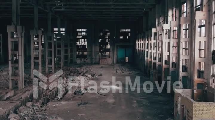 4k aerial view. Destroyed abandoned factory after the war, broken glass, destruction, frightening industrial composition, parallax dolly zoom effect