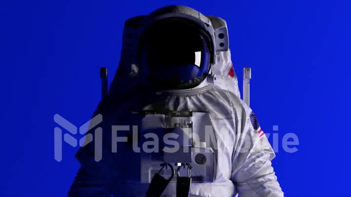 The head of an astronaut on a blue background. Lighting is changing. Chroma key. Helmet. Dark and light. 3d animation