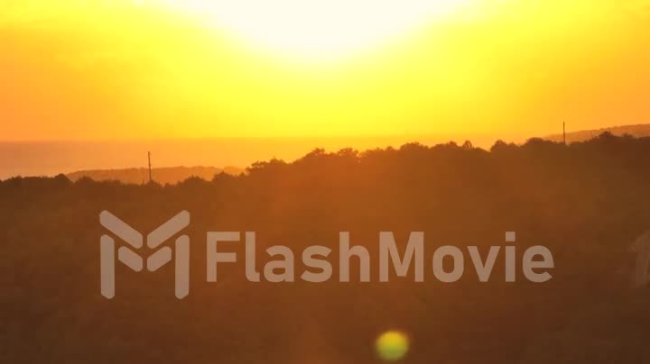 Beautiful yellow-orange sunset over the hills. Landscape. Drone video 4k footage