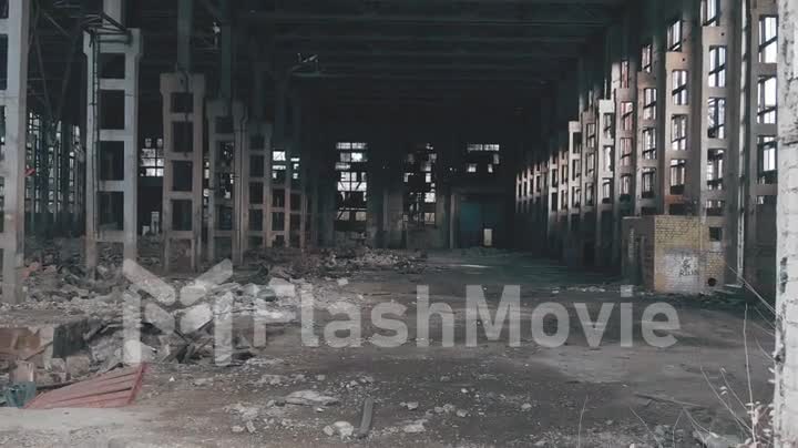 4k aerial view. Destroyed abandoned factory after the war, broken glass, destruction, frightening industrial composition, parallax dolly zoom effect