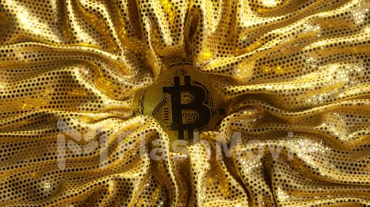 The bitcoin is surrounded by a bright golden fabric. Cryptocurrency. Gold coin. 3d animation